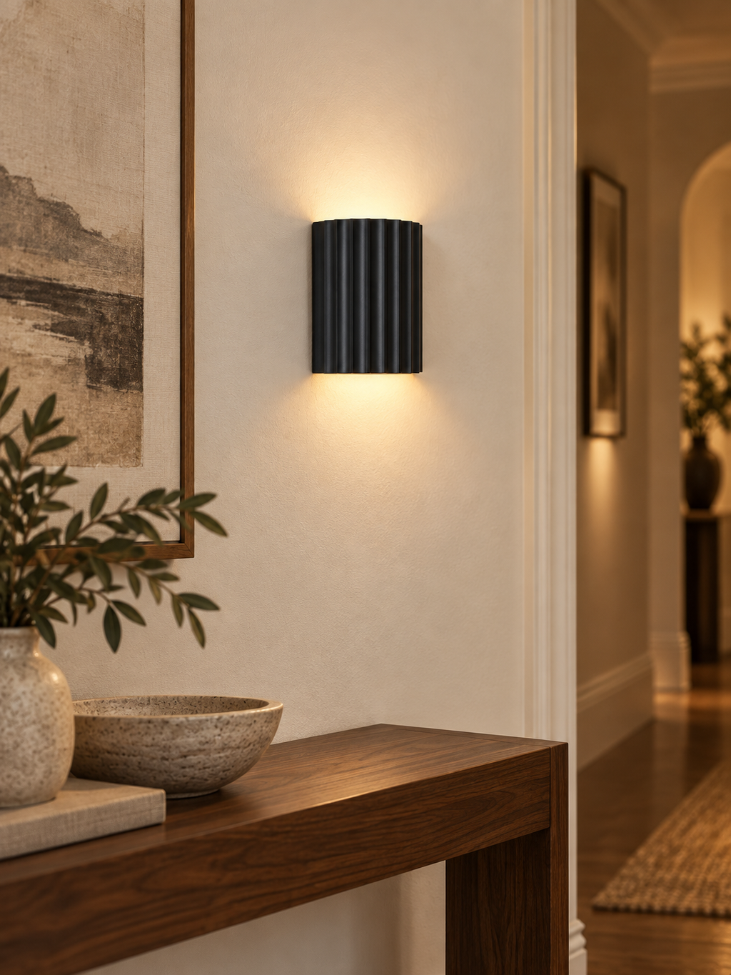Black fluted wall sconce in a modern hallway