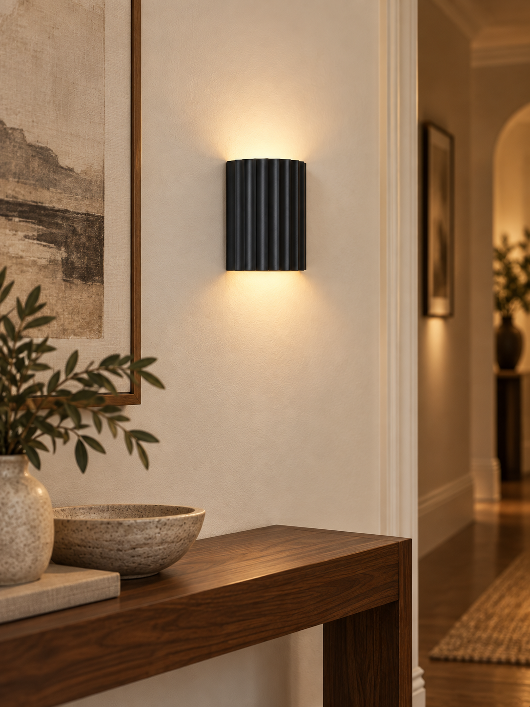 Black fluted wall sconce in a modern hallway