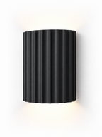 Black fluted resin wall sconce on white background