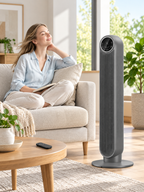 Gray bladeless tower fan beside a sofa in a bright living room