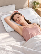 White cervical support pillow supporting a back sleeper in a bright bedroom