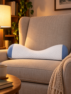 White and blue contoured lumbar pillow displayed on a high-back reading chair