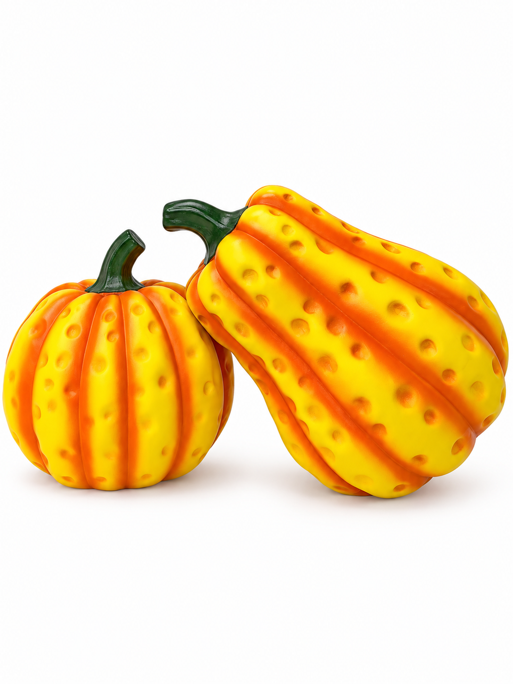 Two dimpled yellow-orange pumpkin sculptures on a white background