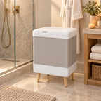 Foldable towel warmer bucket beside a modern shower