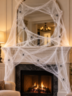 White Halloween spider web with nine black spiders across a fireplace mantel