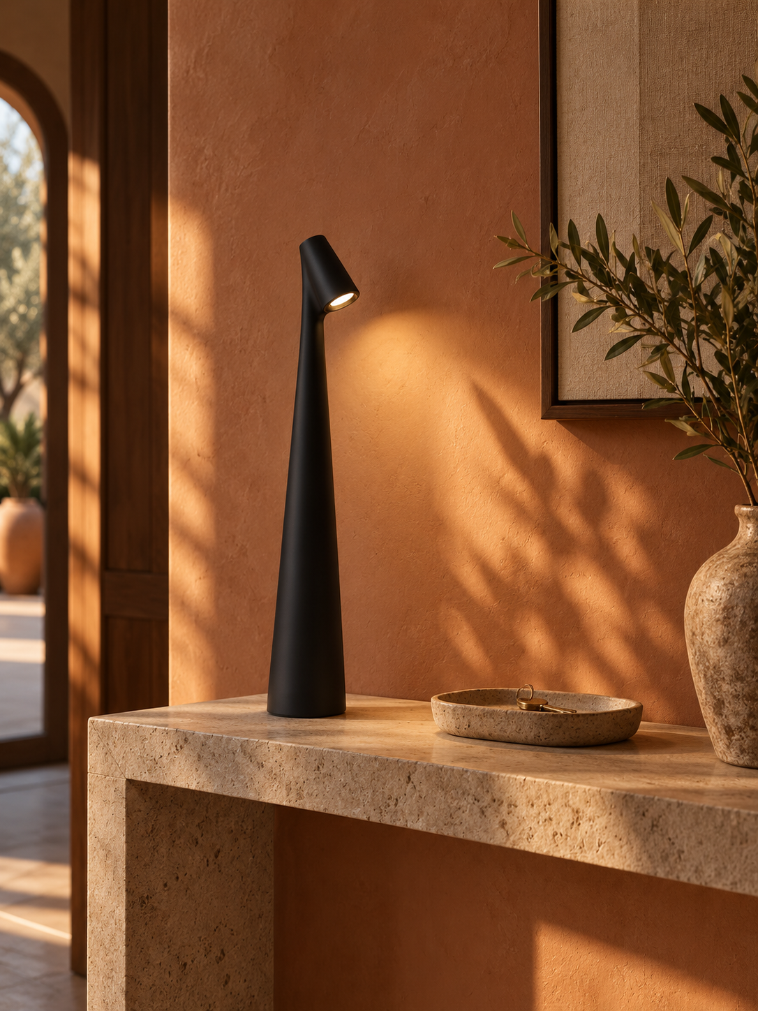 Black rechargeable LED table lamp on a stone entryway console