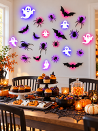 Glowing Halloween ghost bat and spider wall decorations above a dessert buffet