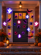 Glowing Halloween ghost bat and spider decorations around a front porch doorway