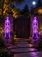 Two purple LED skeleton solar stake lights beside a backyard garden gate