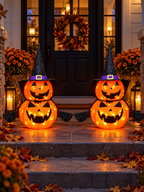 Two illuminated stacked jack-o-lantern decorations flanking a front porch