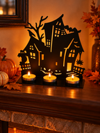 Haunted house metal tealight holder glowing on a fireplace mantel