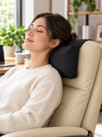 Black headrest pillow supporting an adult in a modern office chair
