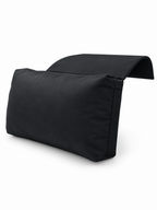 Black headrest pillow with non-slip flap on a seamless white background