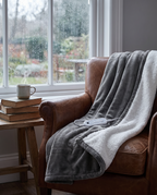 Electric heated blanket in use by a rainy window reading nook