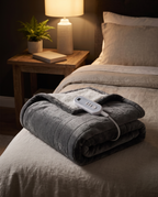 Electric heated blanket in use on a bedroom bed at night
