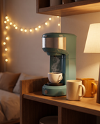 Single-serve coffee maker in a cozy studio kitchenette, evening