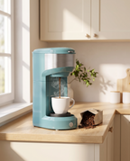 Single-serve coffee maker brewing coffee in a kitchen, early morning