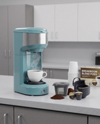 Single-serve coffee maker on an office breakroom counter, midday