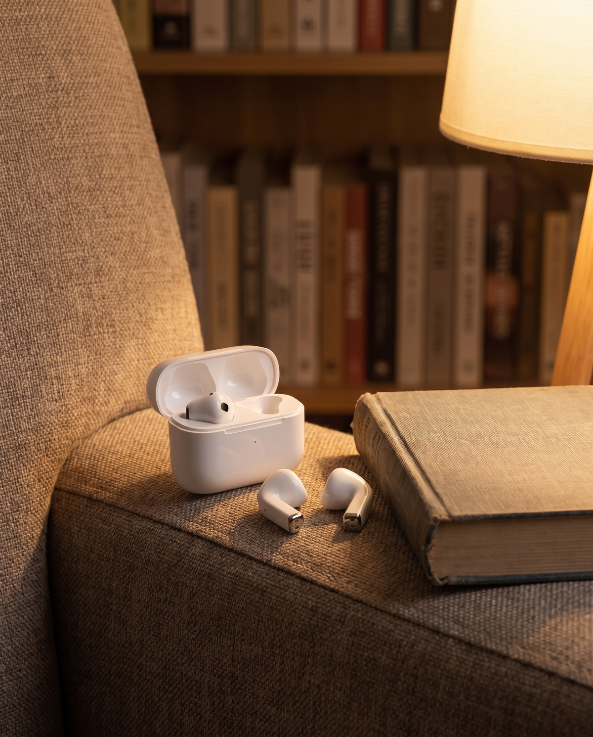 Smart wireless over-ear headphones in a cozy reading nook, evening