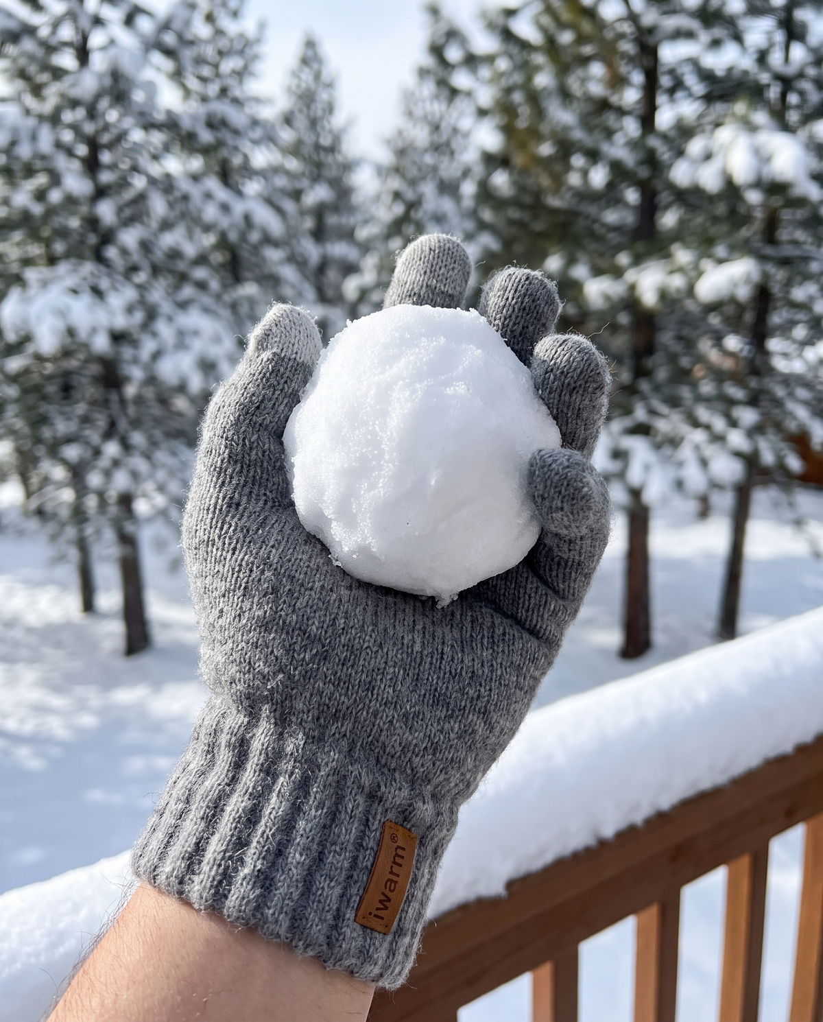 Rechargeable heated gloves worn outdoors in the snow, winter midday