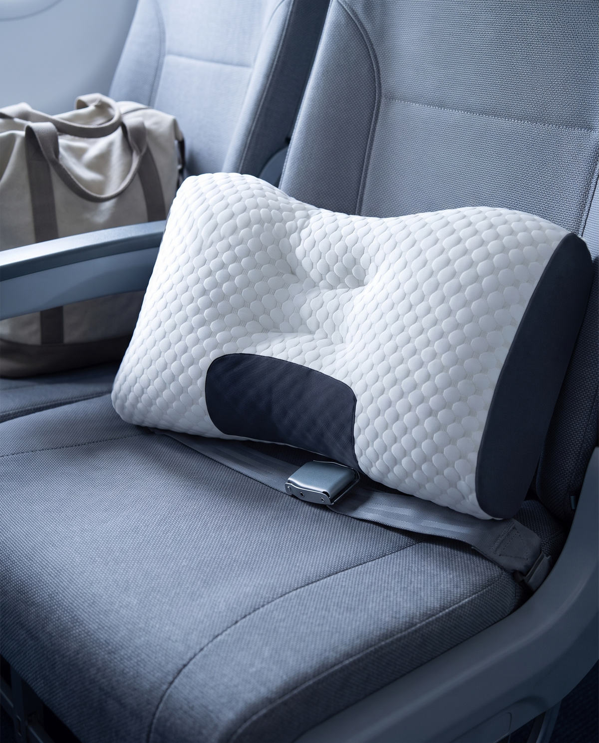 Ergonomic cervical pillow on a travel seat headrest
