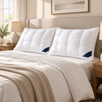 Set of two white quilted bed pillows styled on a bed
