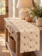 Cream knit pumpkin table runner styled on a rustic entryway console