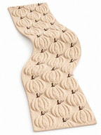 Cream cable knit pumpkin Halloween table runner on a seamless white background