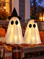 Two lighted white Halloween ghost figurines on a covered front porch bench