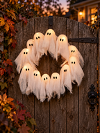 Lighted twelve-ghost Halloween wreath hanging on a wooden garden gate