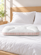 White and pink striped medium support pillow on a bright modern bed