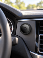 Black mini wireless magnetic camera mounted inside a parked car