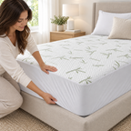 Waterproof bamboo mattress protector fitted on a modern bed