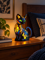 Stained glass cat table lamp on a bedroom nightstand