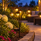 Retro Solar Garden Lantern illuminating a backyard patio flower border