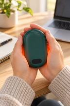 Green rechargeable hand warmer in use during a desk break