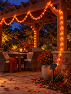 Orange solar chain string lights decorating a backyard pergola