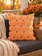 Peach pumpkin motif throw pillow on a covered autumn porch bench