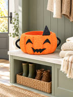 Orange pumpkin Halloween storage basket on a sage green mudroom bench