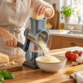 Stainless steel rotary cheese grater preparing cheese in a bright kitchen