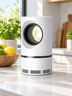 White cylindrical UV mosquito and fly trap on a bright kitchen counter