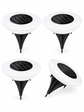 Four-pack of solar ground lights on white background