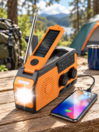 Solar hand crank emergency radio at a forest campsite