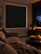 Black static cling blackout shade installed in a cozy home theater