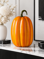 Tall glossy orange pumpkin figure on a modern console