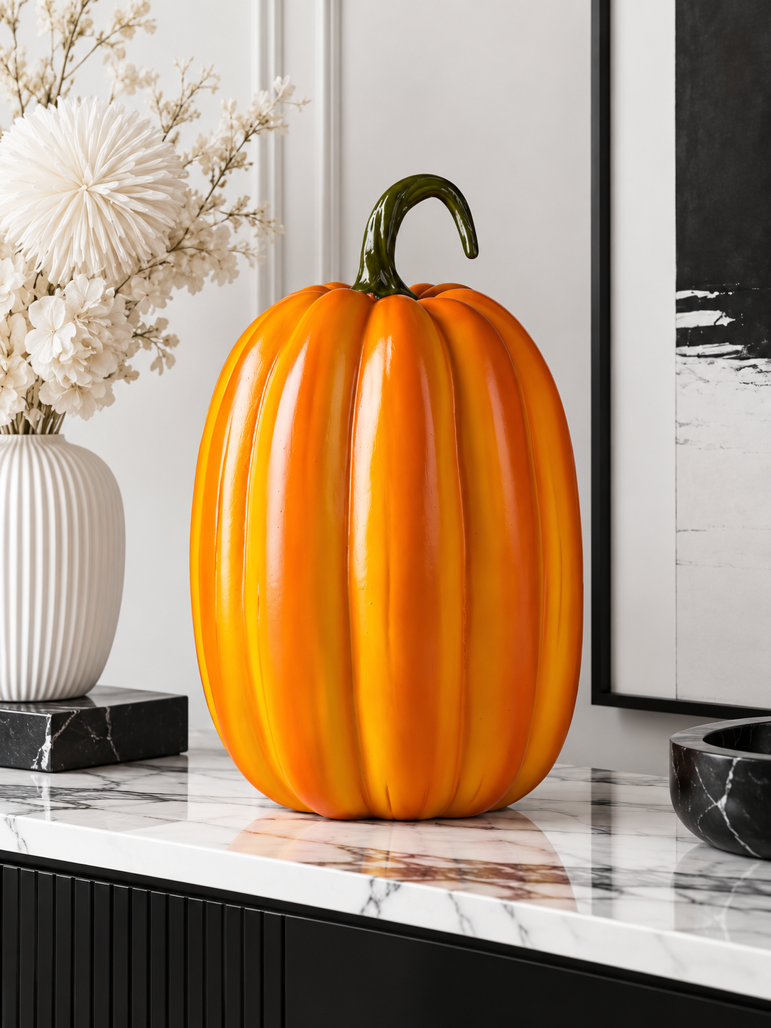 Tall glossy orange pumpkin figure on a modern console