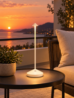 White rechargeable cordless touch lamp on a balcony at sunset