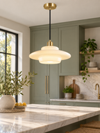 White glass pendant light above a modern sage kitchen island