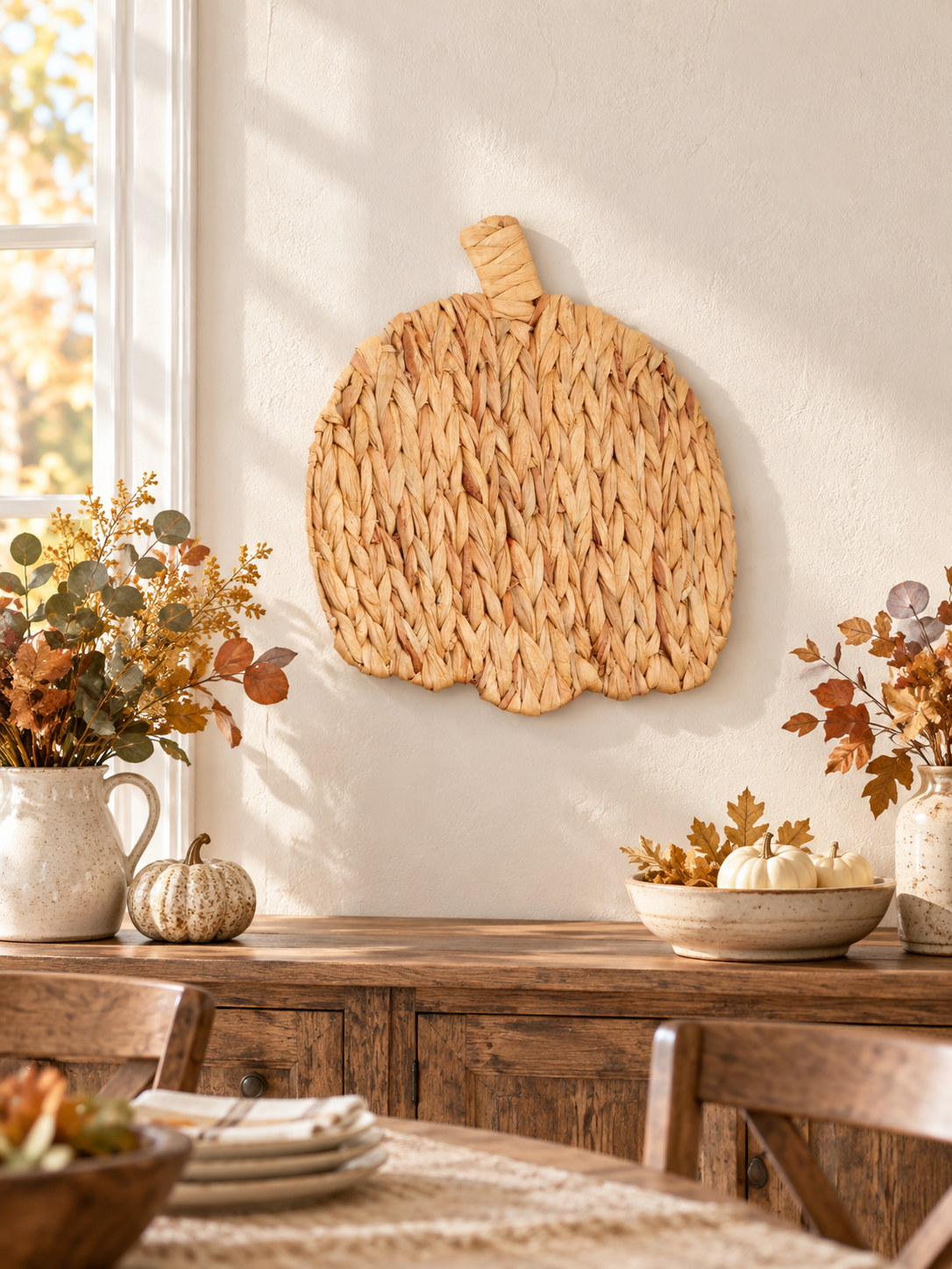 Natural woven pumpkin wall art in a farmhouse dining room